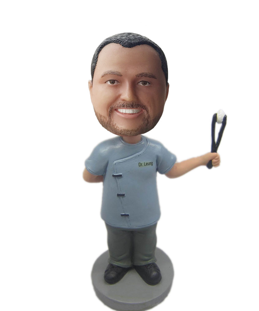 Male physician bobbleheads holding up with a operating forceps B239-1