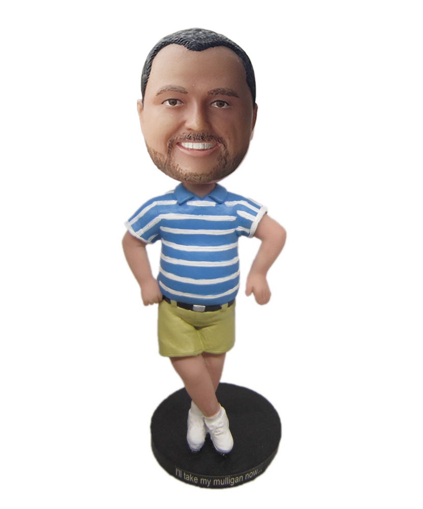 dashboard doll bobble head dressed in blue shirt and dark yellow shorts