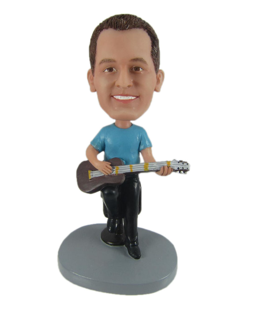 Male guitar playing bobblehead sitting on a stool